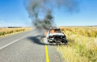 Local volunteer firefighter assists in extinguishing burning vehicle