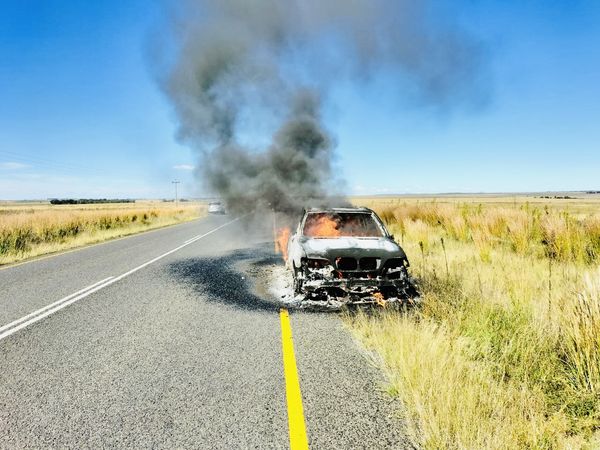 Local volunteer firefighter assists in extinguishing burning vehicle