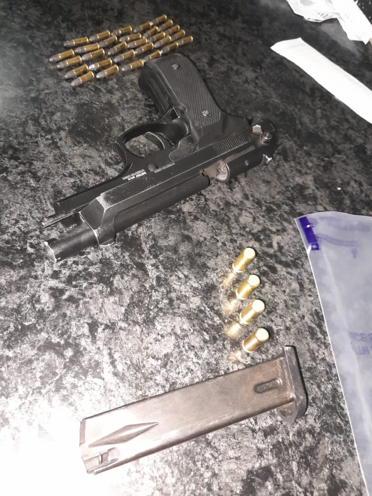 Police members arrest suspects for possession of unlicensed firearms and ammunition