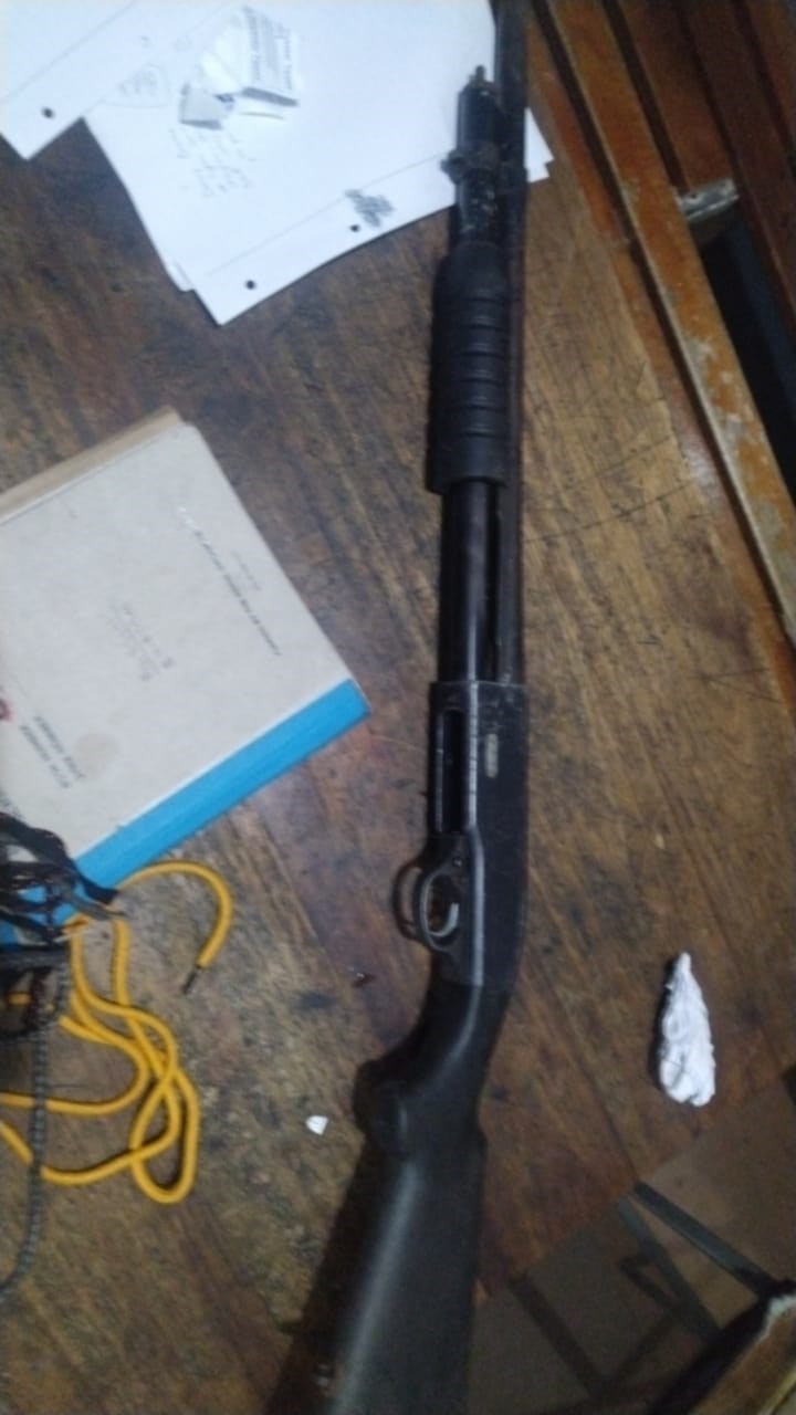 Police members detain two suspects on charges of possession of unlicensed firearms and ammunition