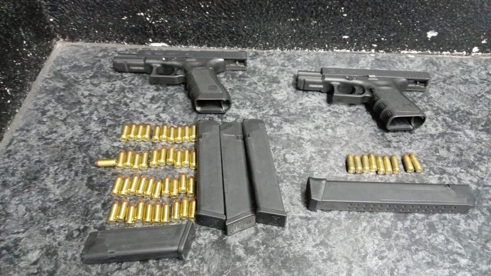 Police arrest two suspects for the illegal possession of firearms and ammunition