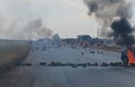 The R550 road is currently barricaded with stones and burning tyres due to protest action in the area